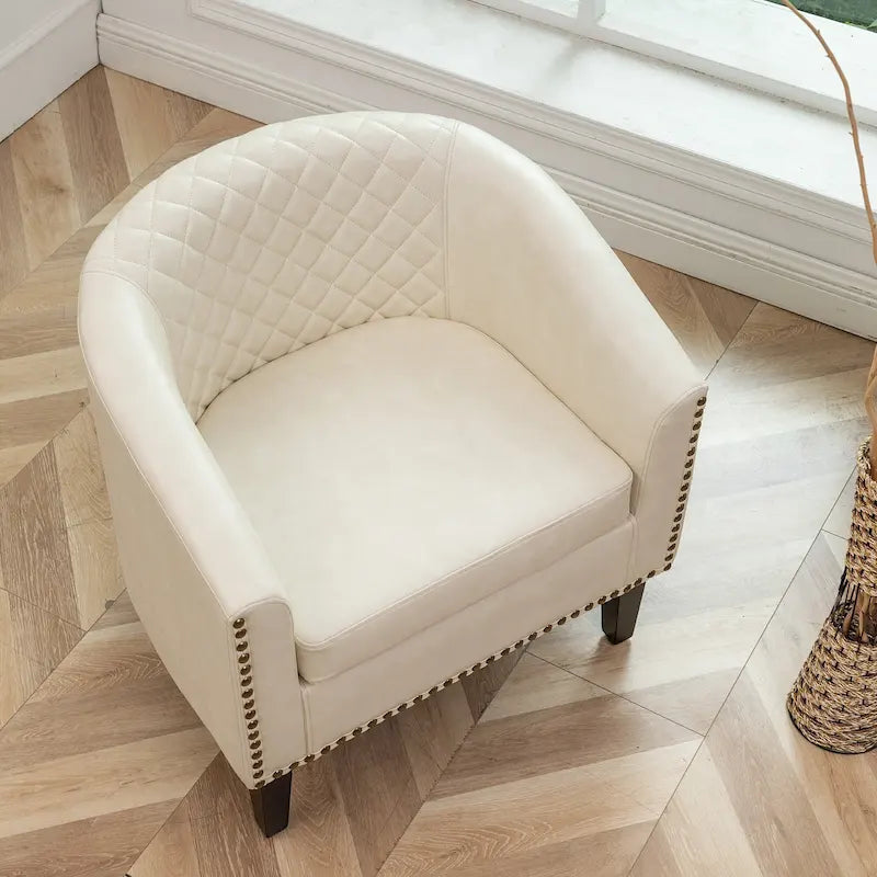Poltrona club a botte in pelle PU trapuntata con borchie decorative