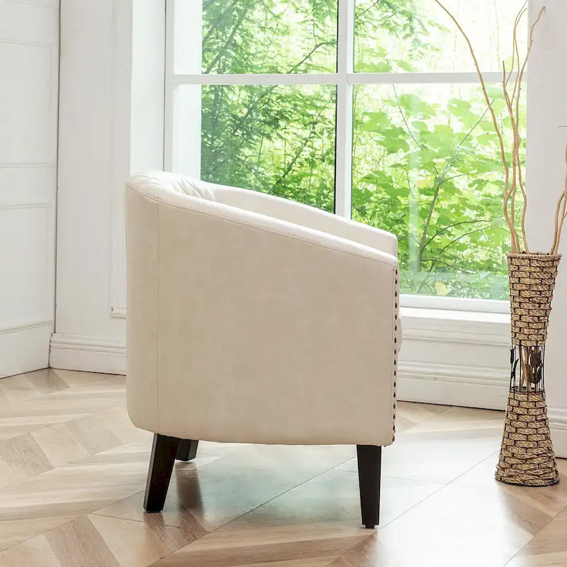 Poltrona club a botte in pelle PU trapuntata con borchie decorative