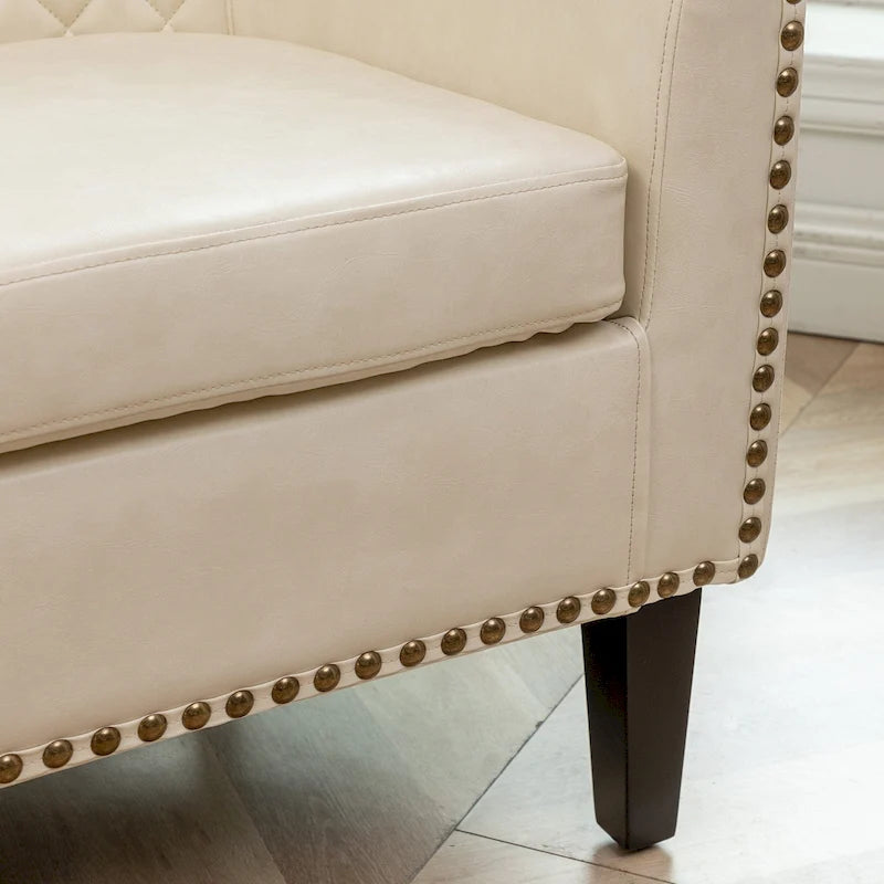 Poltrona club a botte in pelle PU trapuntata con borchie decorative