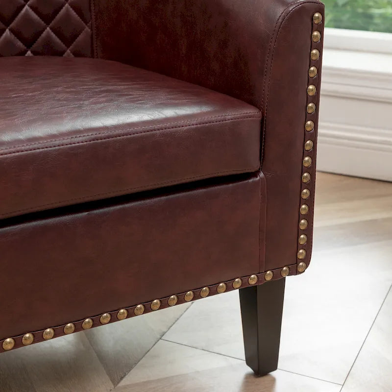 Poltrona club a botte in pelle PU trapuntata con borchie decorative