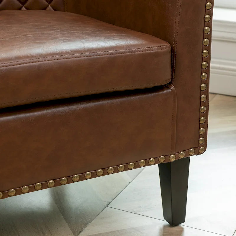 Poltrona club a botte in pelle PU trapuntata con borchie decorative