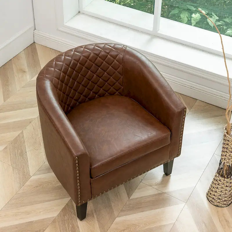 Poltrona club a botte in pelle PU trapuntata con borchie decorative